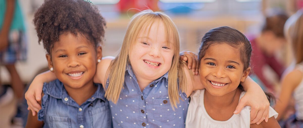 Three diverse friends at kindergarten.