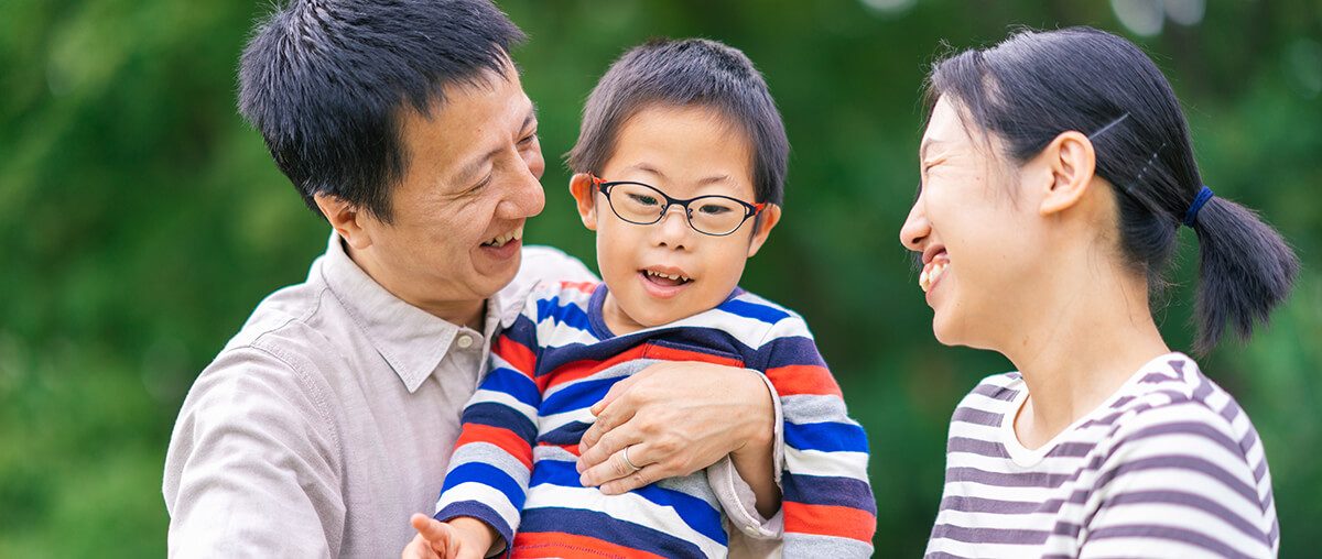 Portrait of happy family with son with down syndrome.